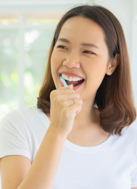 lady brushing her teeth