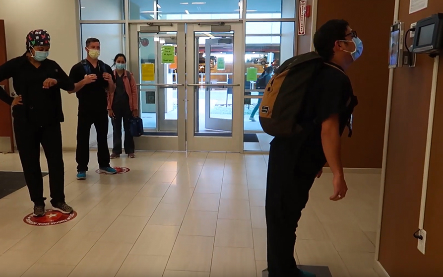 Students perform a scene showing the occasional difficulty with the screening kiosk.