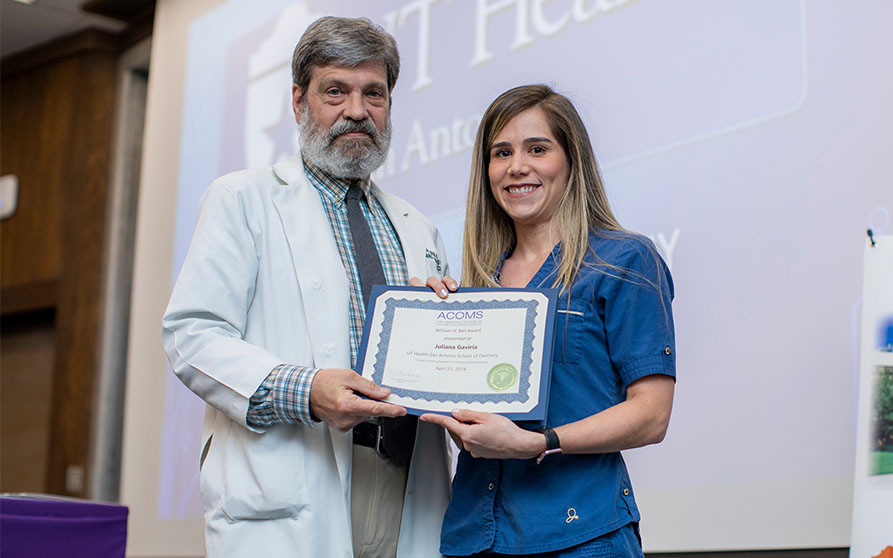 Juliana Gaviria (right) was presented with the ACOMS William H. Bell Award by Dr. Jack Vizuete. <p>Photo Credit: Creative Media Services.</p>