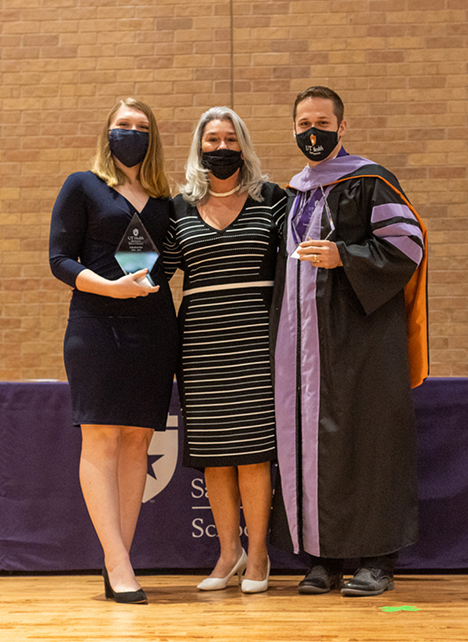 Adriana Segura, DDS, MS (center) poses with Valedictorians, Dakota Miller, DDS (left) and Easton Trejo, DDS (right).