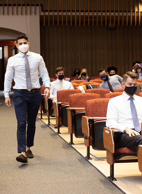 Aziz Saqr, DDS, walks to the stage to accept the International College of Dentists Student Humanitarian Award during the socially distanced cermony.