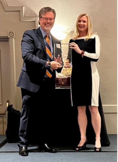 Dr. Cara Gonzales (right) received a gift of appreciation for speaking at the virtual Hollers lecture in 2020.