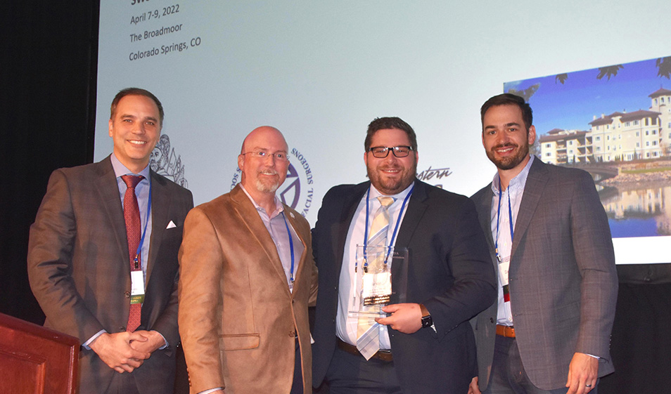 Dr. Jason Jones receives the Southwest Society of OMS Byrd/Tilson/Walker award standing next to three other Southwest Society of Oral and Maxillofacial Surgeons