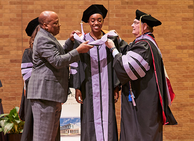 Doctoral hooding: Dr. Joi Walls (center), her father Dr. J.J. Walls (left) and Dr. Bill Rose (right)