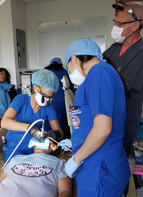 Dr. Heather Burbick conducting a procedure with the assistance of Peronia clinic staff and support of her father, Dr. Joseph Burbick.