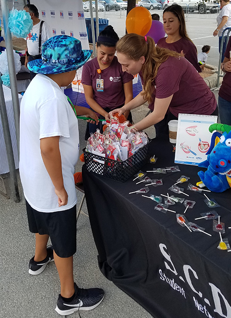 Giving out goodie bags and sugar-free treats.