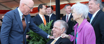 UT Health San Antonio President William L. Henrich, M.D., MACP, greets Lowry and Peggy Mays at the naming ceremony for the Mays Cancer Center.