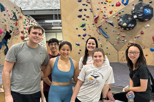 Students at a climbing gym smiling together